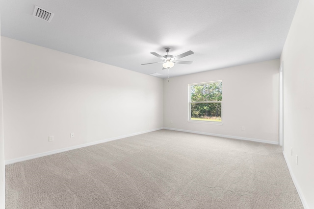 unfurnished room featuring ceiling fan and light carpet