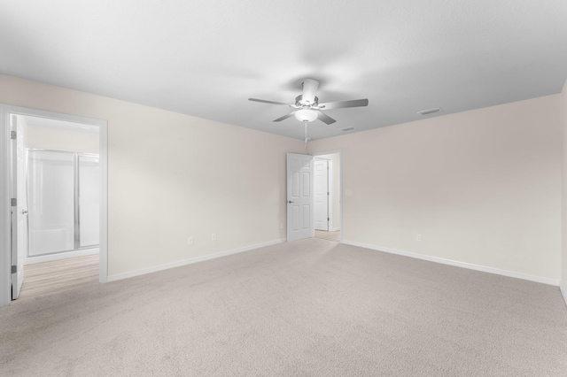 carpeted spare room with ceiling fan