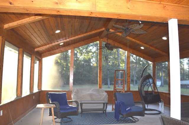 sunroom with vaulted ceiling with beams, a healthy amount of sunlight, ceiling fan, and wood ceiling