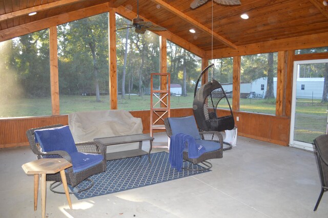 sunroom / solarium featuring lofted ceiling with beams, ceiling fan, and wood ceiling