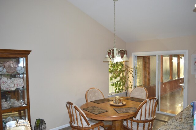 dining area featuring a notable chandelier and vaulted ceiling