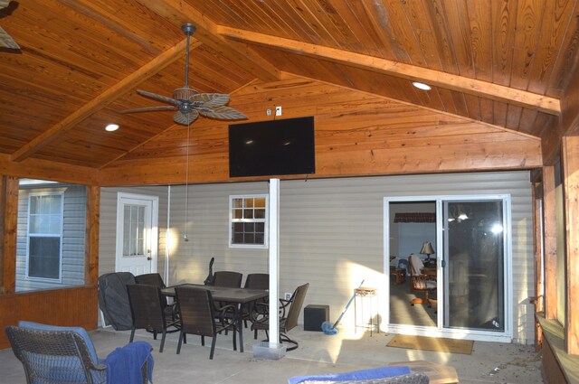 sunroom with ceiling fan, wood ceiling, and vaulted ceiling with beams