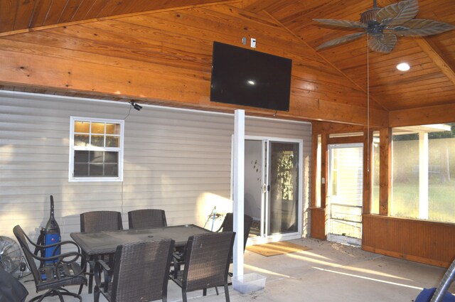 sunroom with ceiling fan, wood ceiling, and vaulted ceiling