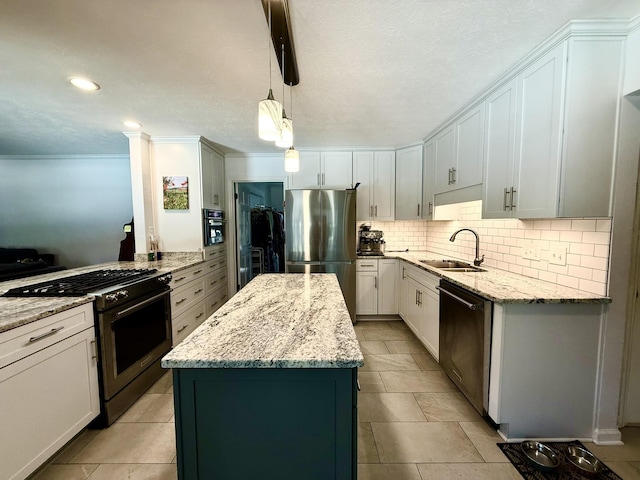 kitchen featuring a sink, a center island, appliances with stainless steel finishes, decorative backsplash, and light stone countertops