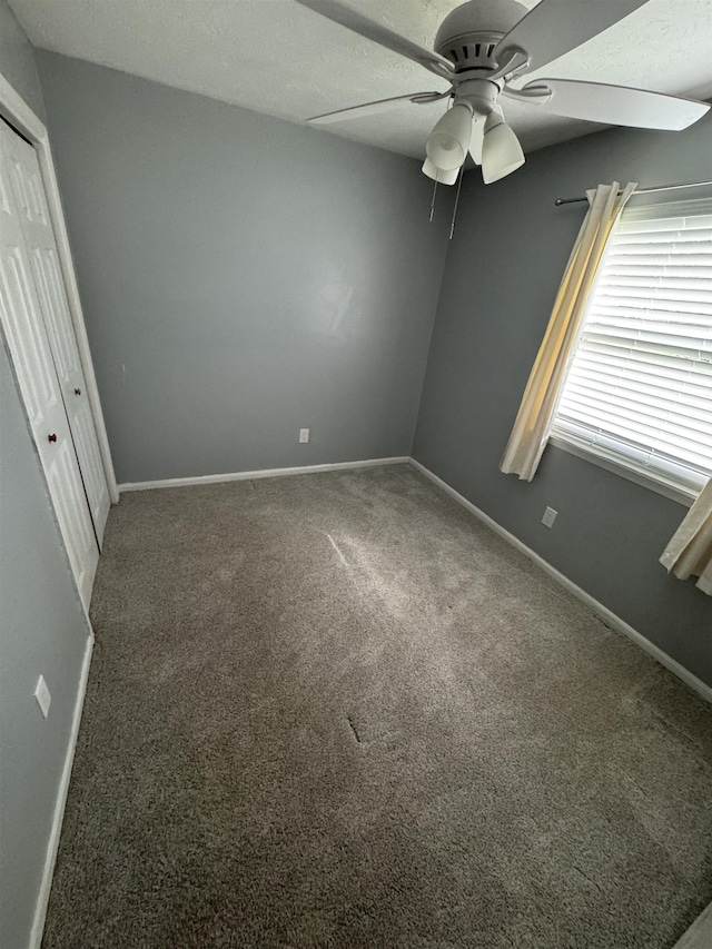2408 Ionic Ct, Tallahassee, FL 32303 - unfurnished bedroom with carpet flooring, a closet, and a ceiling fan