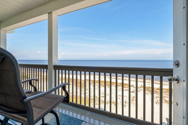 balcony featuring a water view and a beach view