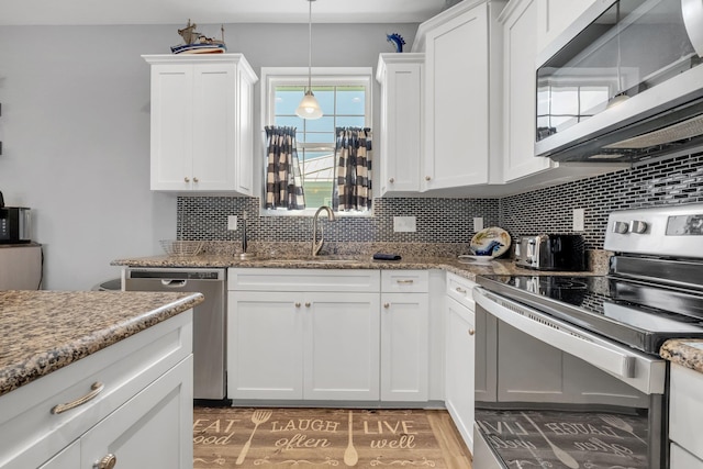 kitchen with white cabinetry, sink, stainless steel appliances, tasteful backsplash, and light hardwood / wood-style floors