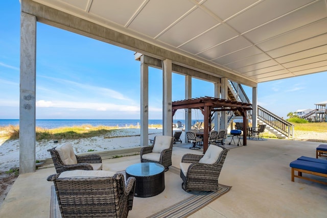 view of patio with a water view and a beach view