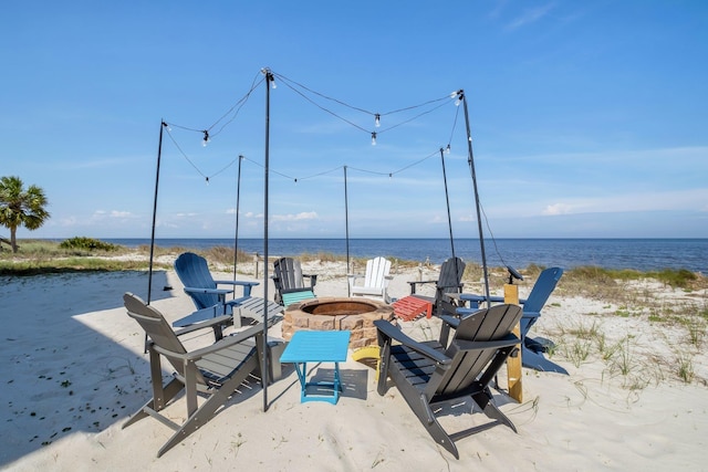 view of patio featuring a fire pit and a water view