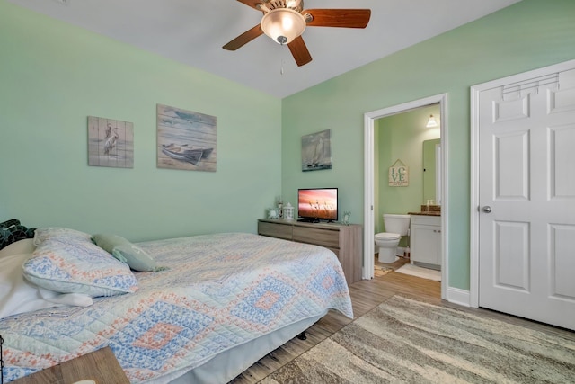 bedroom featuring ceiling fan, light hardwood / wood-style floors, and ensuite bathroom