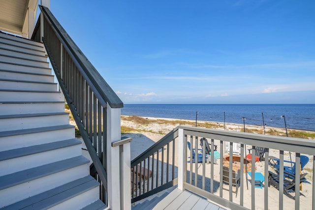 wooden terrace featuring a water view