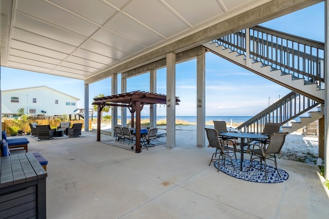 view of patio featuring a pergola, an outdoor living space, and a water view