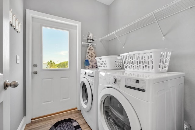 laundry area featuring light wood-type flooring and independent washer and dryer