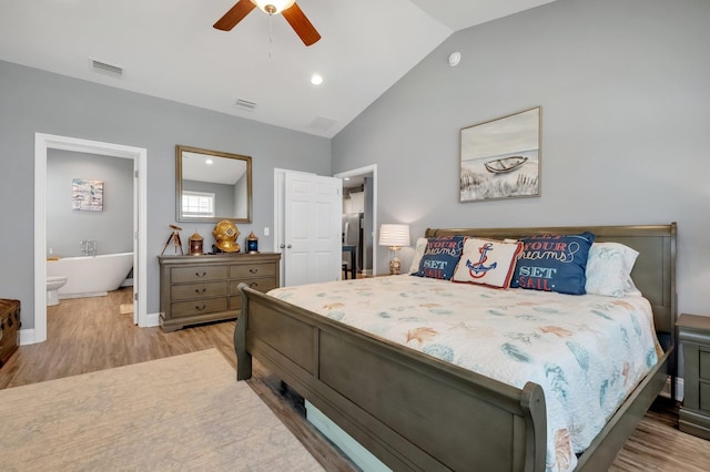 bedroom featuring lofted ceiling, ensuite bathroom, ceiling fan, and light hardwood / wood-style floors