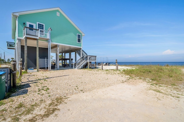 back of property featuring a water view