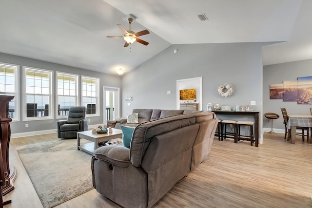 living room featuring light wood-type flooring, ceiling fan, and lofted ceiling