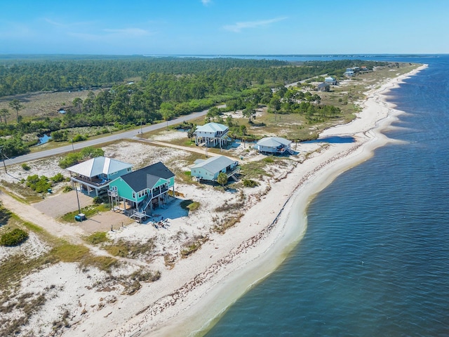 birds eye view of property with a water view and a view of the beach