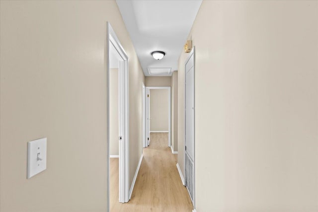 corridor with light hardwood / wood-style floors