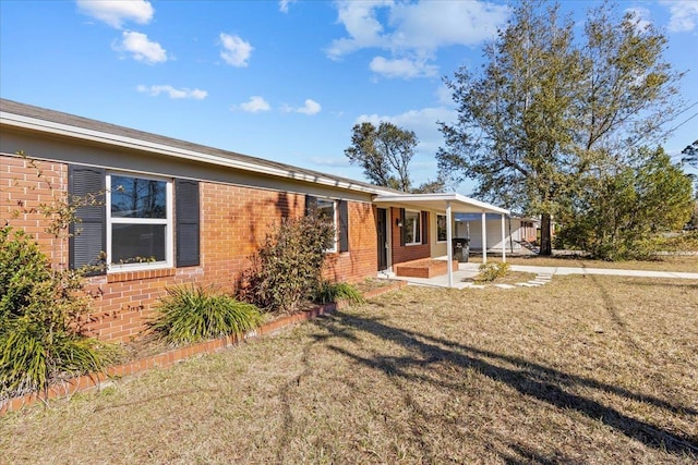 view of front facade with a front lawn and a carport