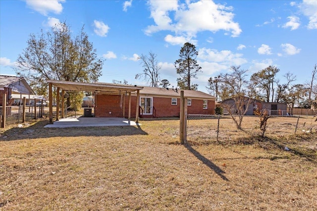 rear view of property with a yard and a patio