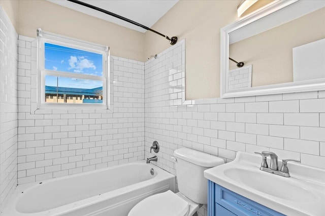 full bathroom with toilet, tiled shower / bath combo, tasteful backsplash, tile walls, and vanity