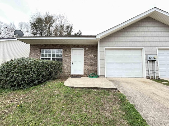 ranch-style house with a garage and a front lawn