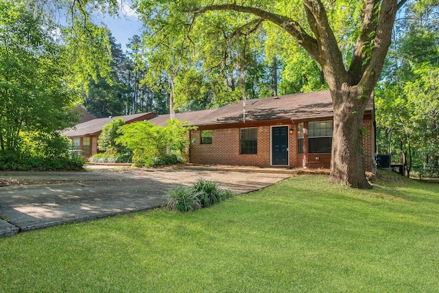 1541 San Luis Rd, Tallahassee, FL 32304 - single story home featuring brick siding, central AC, a front lawn, and aphalt driveway