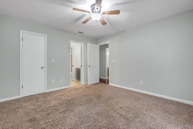 1541 San Luis Rd, Tallahassee, FL 32304 - unfurnished bedroom featuring connected bathroom, ceiling fan, light colored carpet, baseboards, and visible vents