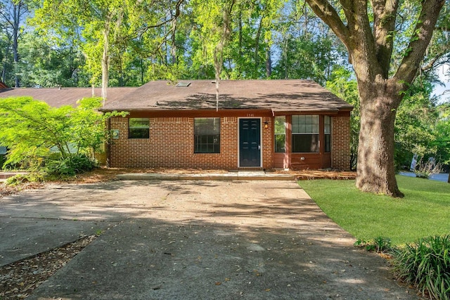 1541 San Luis Rd, Tallahassee, FL 32304 - single story home with roof with shingles, concrete driveway, and brick siding