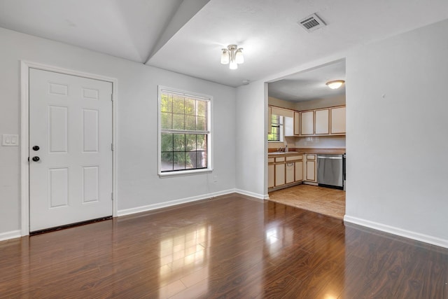 1541 San Luis Rd, Tallahassee, FL 32304 - unfurnished living room featuring visible vents, a sink, baseboards, and wood finished floors
