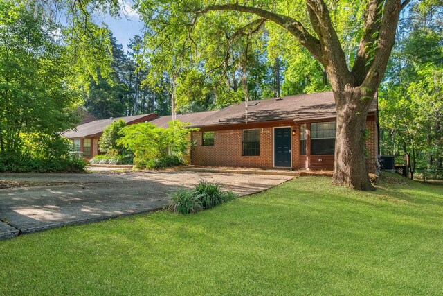 1541 San Luis Rd, Tallahassee, FL 32304 - ranch-style home featuring central AC, driveway, a front lawn, and brick siding