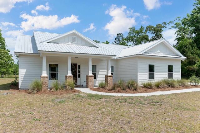 1740 Wakulla Arran Rd, Crawfordville, FL 32327 - view of front of home featuring board and batten siding, a porch, and metal roof