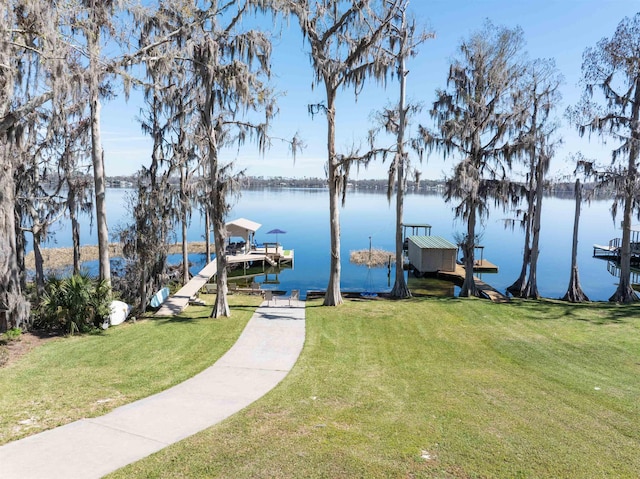 view of dock featuring a yard and a water view