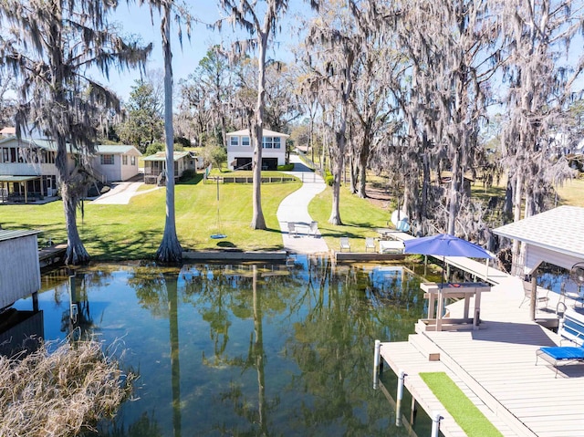 view of dock with a lawn