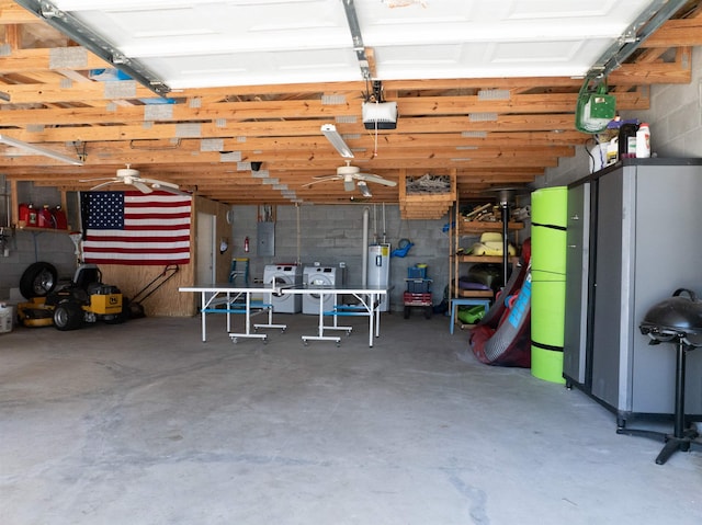 garage featuring electric panel, a garage door opener, water heater, separate washer and dryer, and concrete block wall