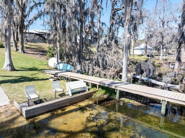 view of dock featuring a yard