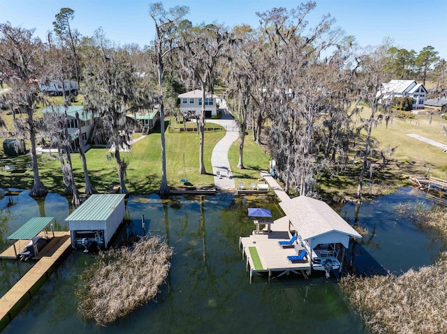 view of dock featuring boat lift, a lawn, and a water view