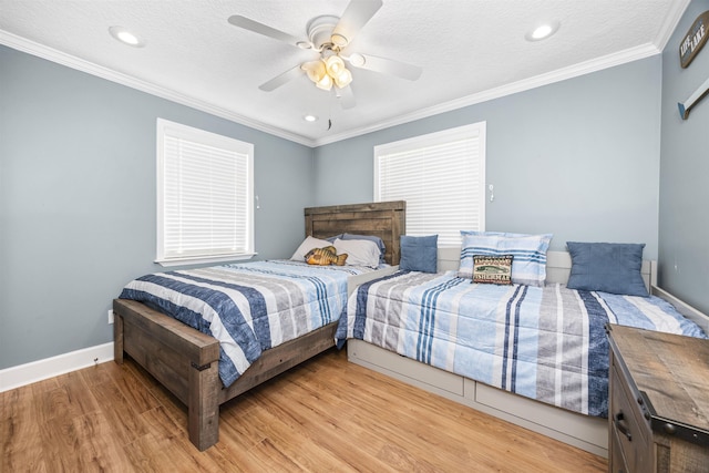 bedroom with baseboards, light wood-style floors, ornamental molding, and a textured ceiling