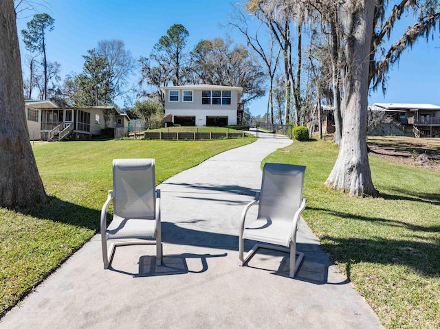 surrounding community featuring a patio and a lawn