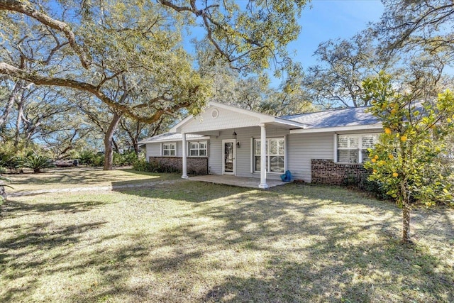 back of property featuring a yard and a patio area