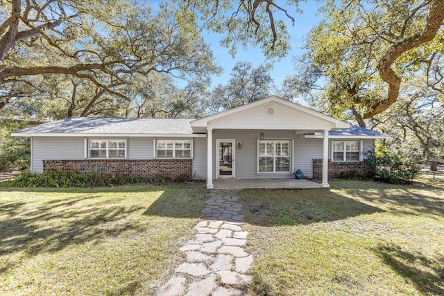 ranch-style house featuring a patio and a front lawn