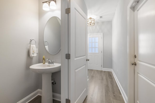 bathroom with hardwood / wood-style flooring and sink