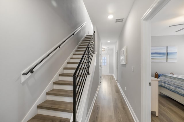 stairs featuring hardwood / wood-style floors