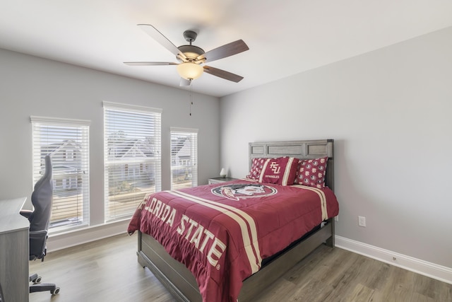 bedroom with ceiling fan and dark hardwood / wood-style flooring