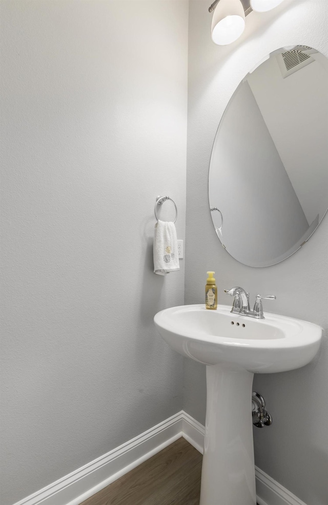 bathroom with sink and hardwood / wood-style floors