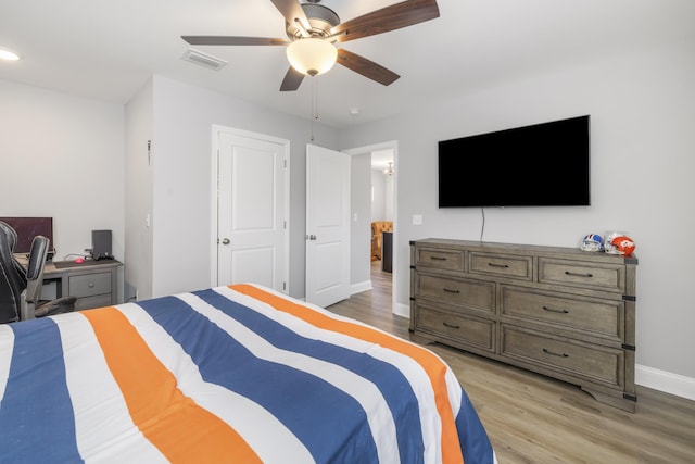 bedroom with ceiling fan and light hardwood / wood-style floors