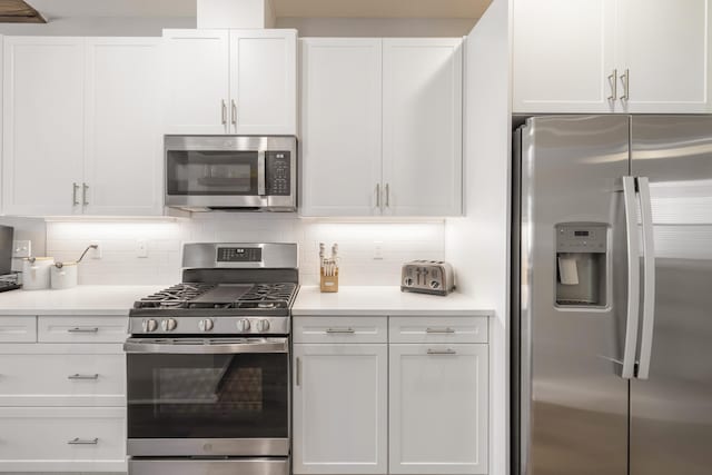 kitchen featuring white cabinetry, decorative backsplash, and appliances with stainless steel finishes