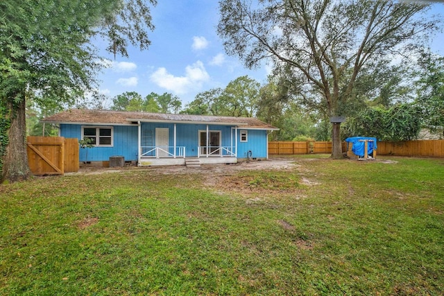 rear view of house with a lawn