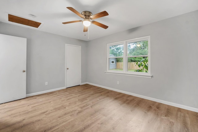 empty room with ceiling fan and light wood-type flooring