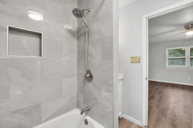 bathroom with ceiling fan, tiled shower / bath combo, and hardwood / wood-style floors